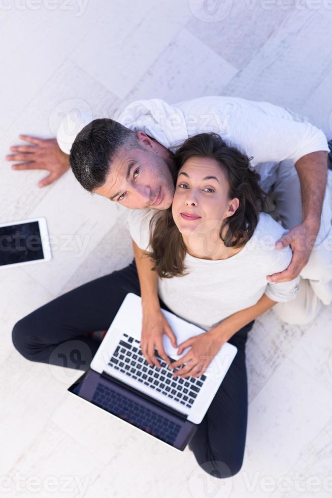 couple using tablet and laptop computers top view photo