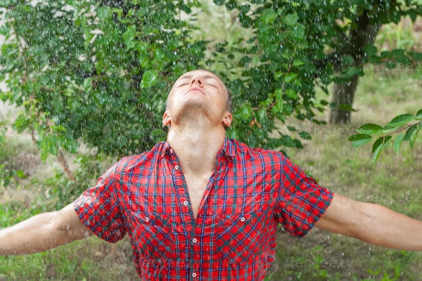 Sexy young man wet in rain photo