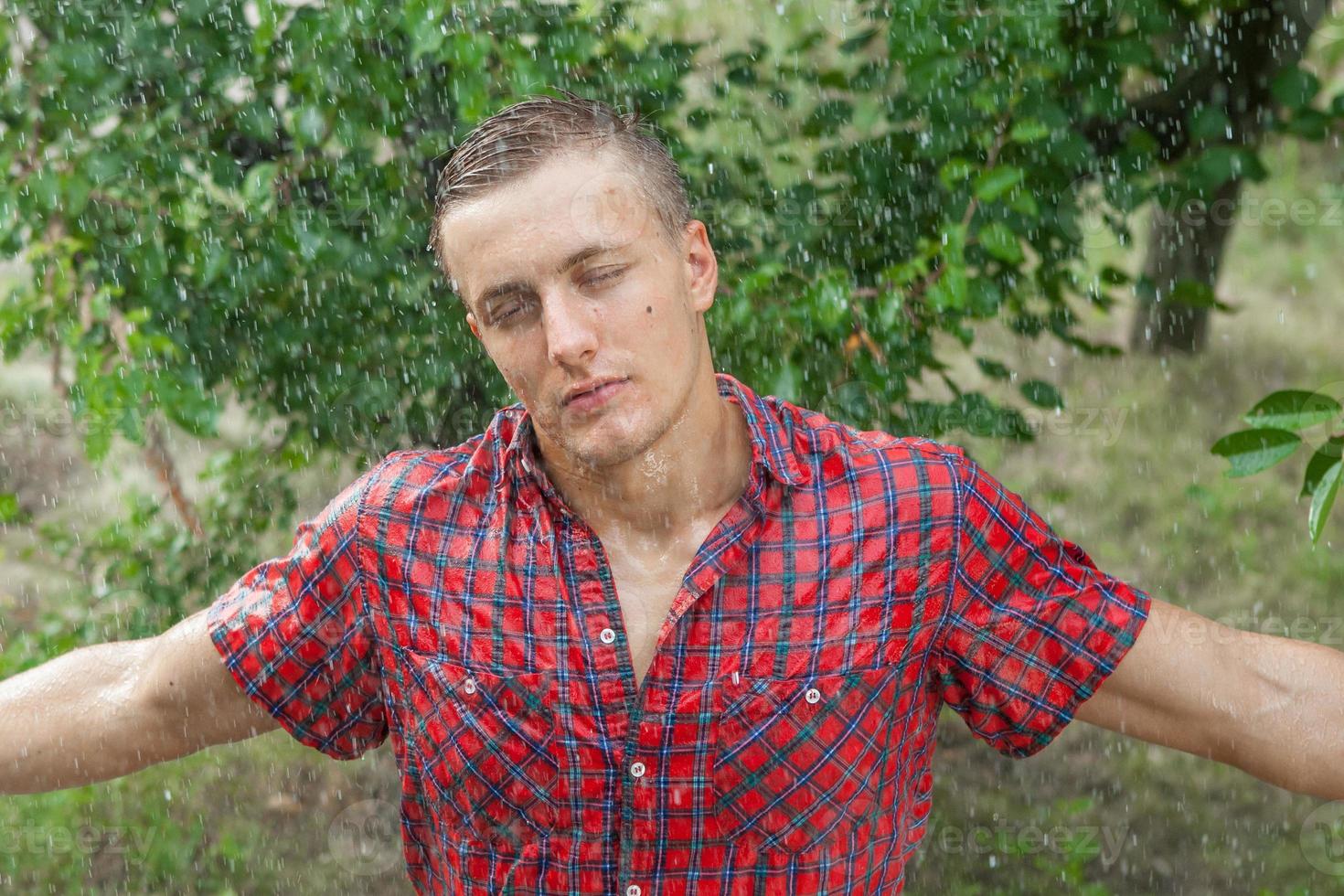 Sexy young man wet in rain photo