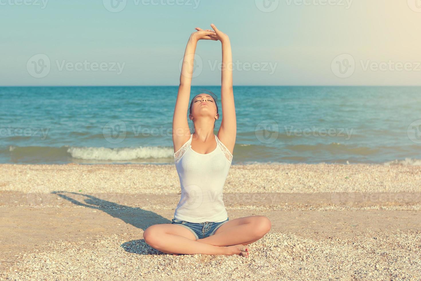 young woman practicing yoga photo