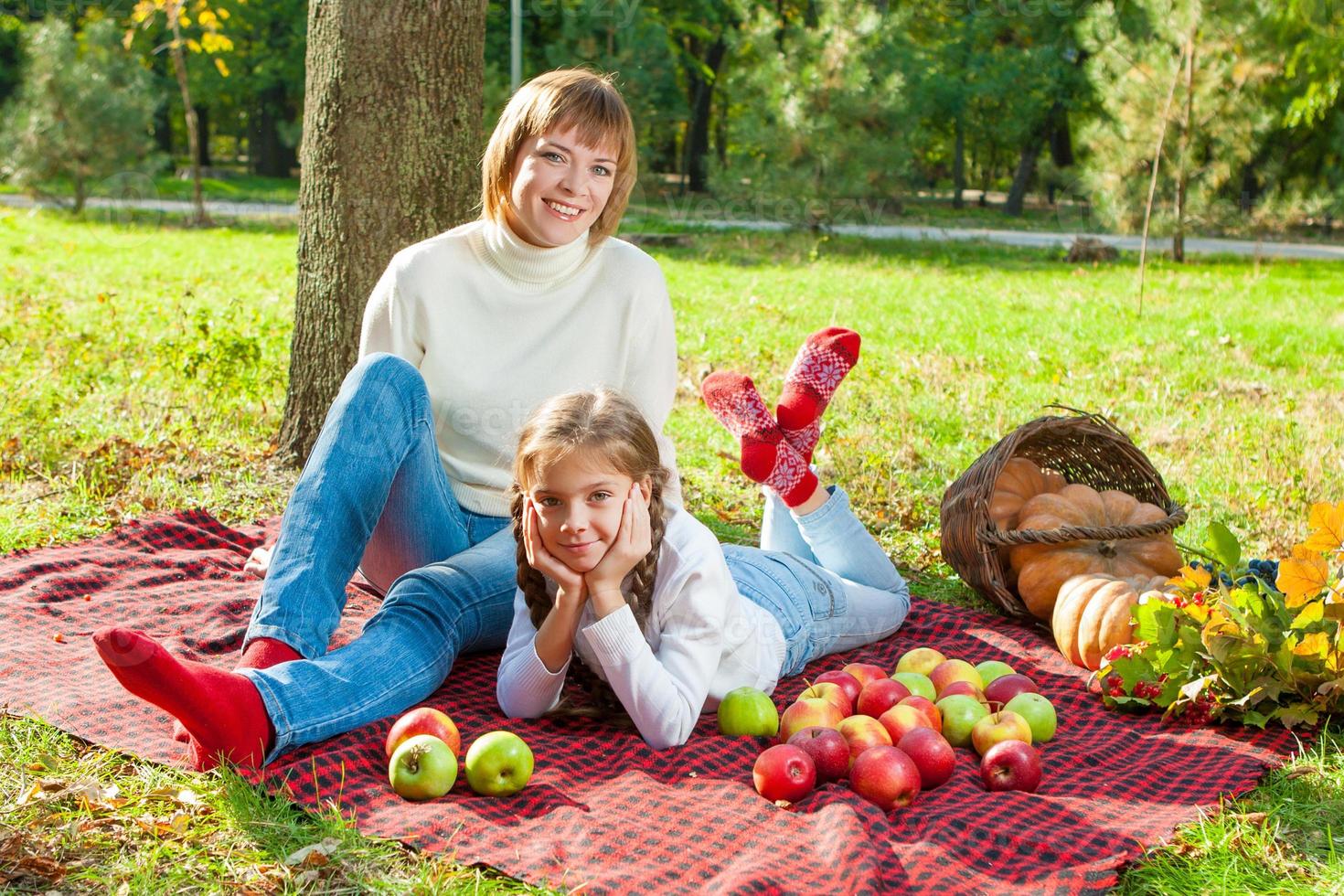 Happy mother with little daughter in autumn park photo