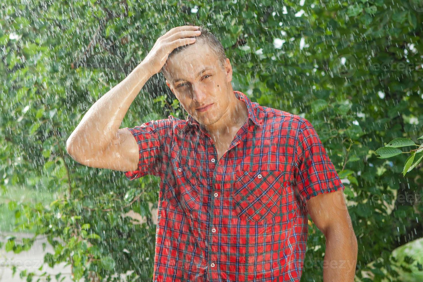 Sexy young man wet in rain photo