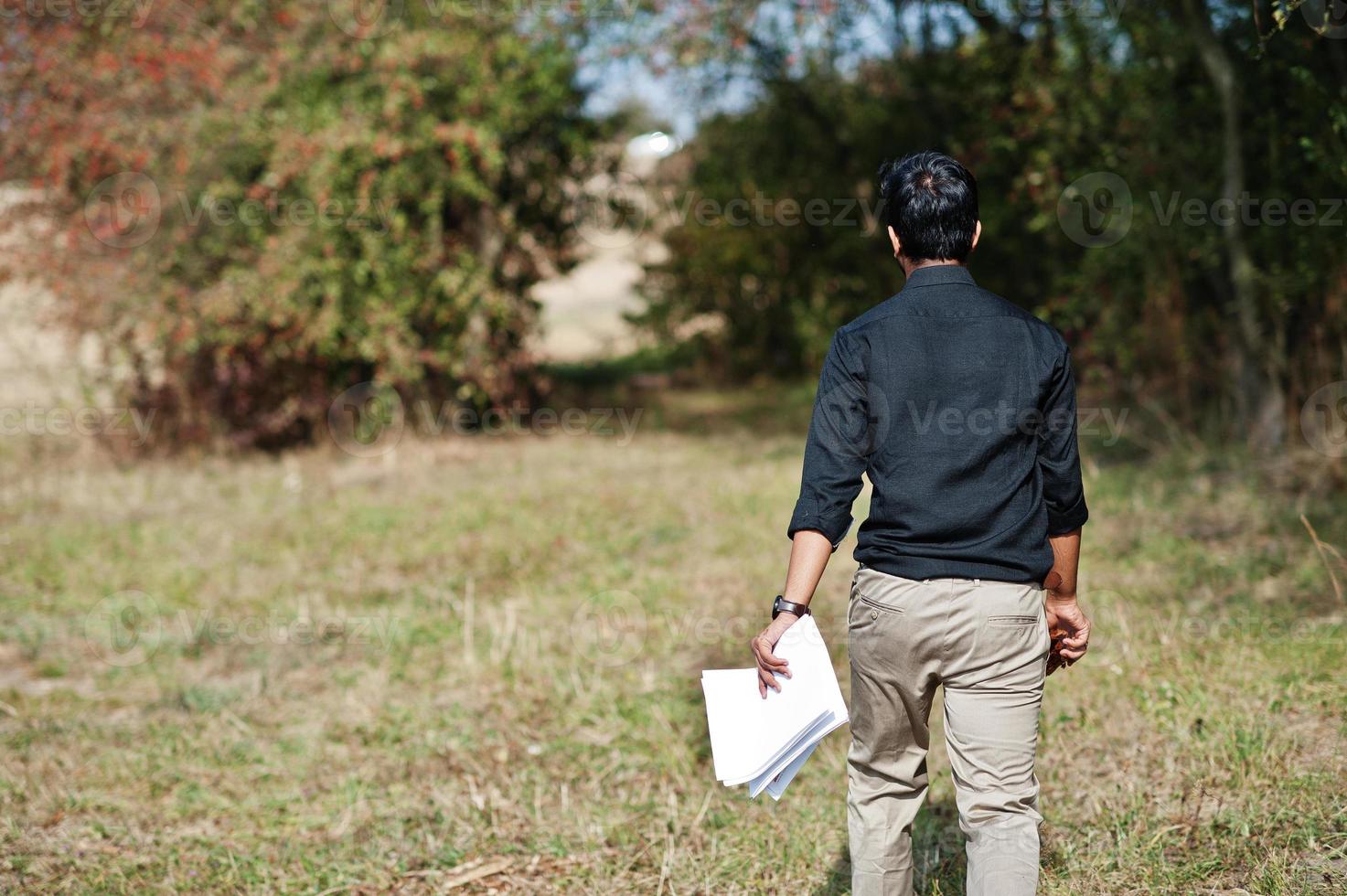 South asian agronomist farmer inspecting his farm. Agriculture production concept. photo