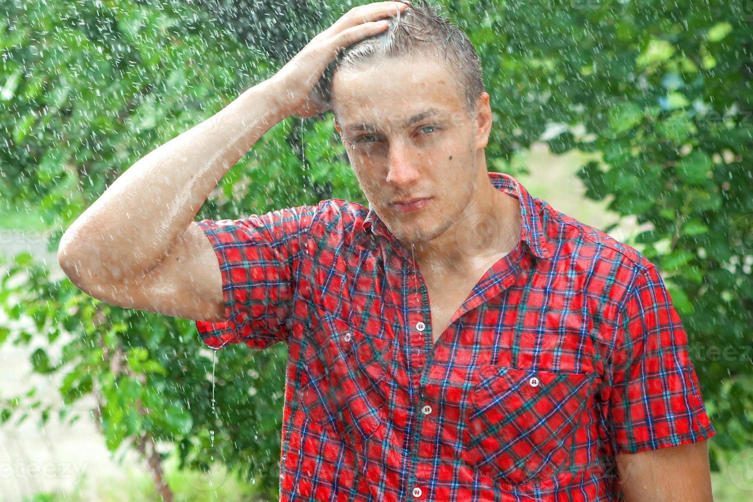 Sexy young man wet in rain photo