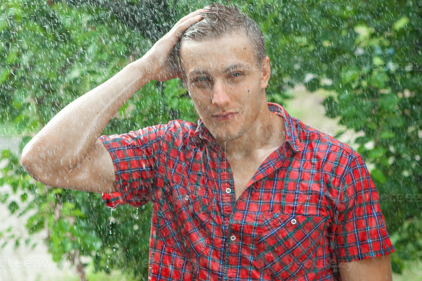 Sexy young man wet in rain photo