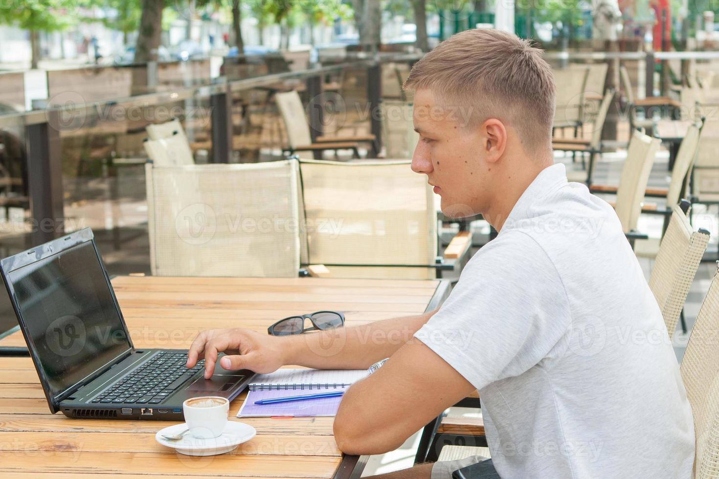 Young man sitting in cafe photo