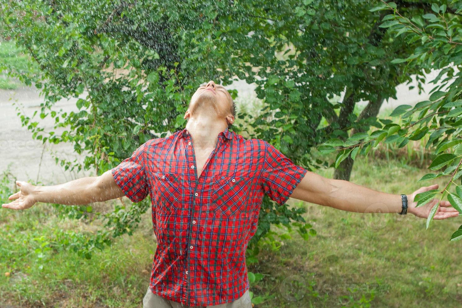 Sexy young man wet in rain photo