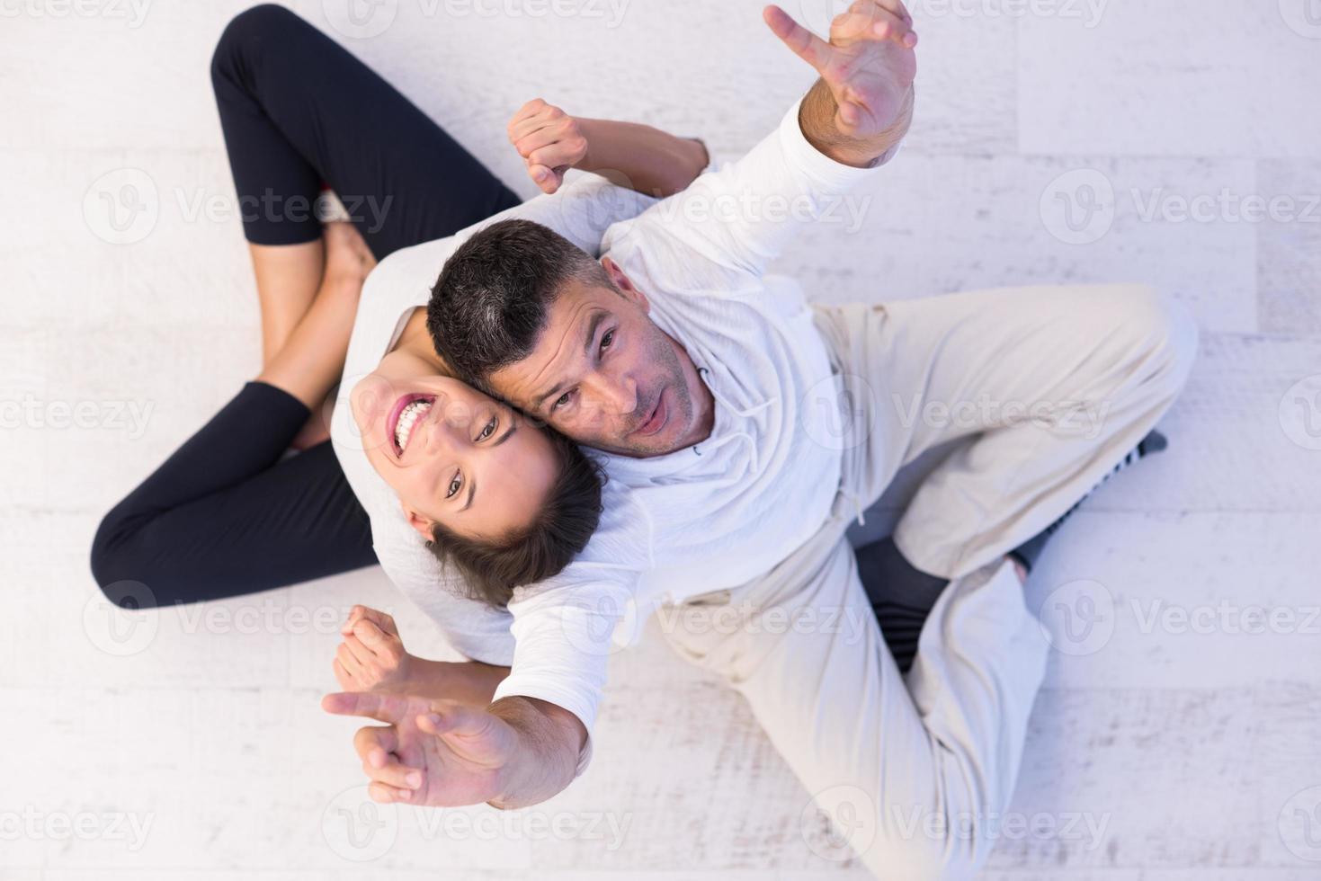 couple sitting with back to each other on floor 10393310 Stock Photo at