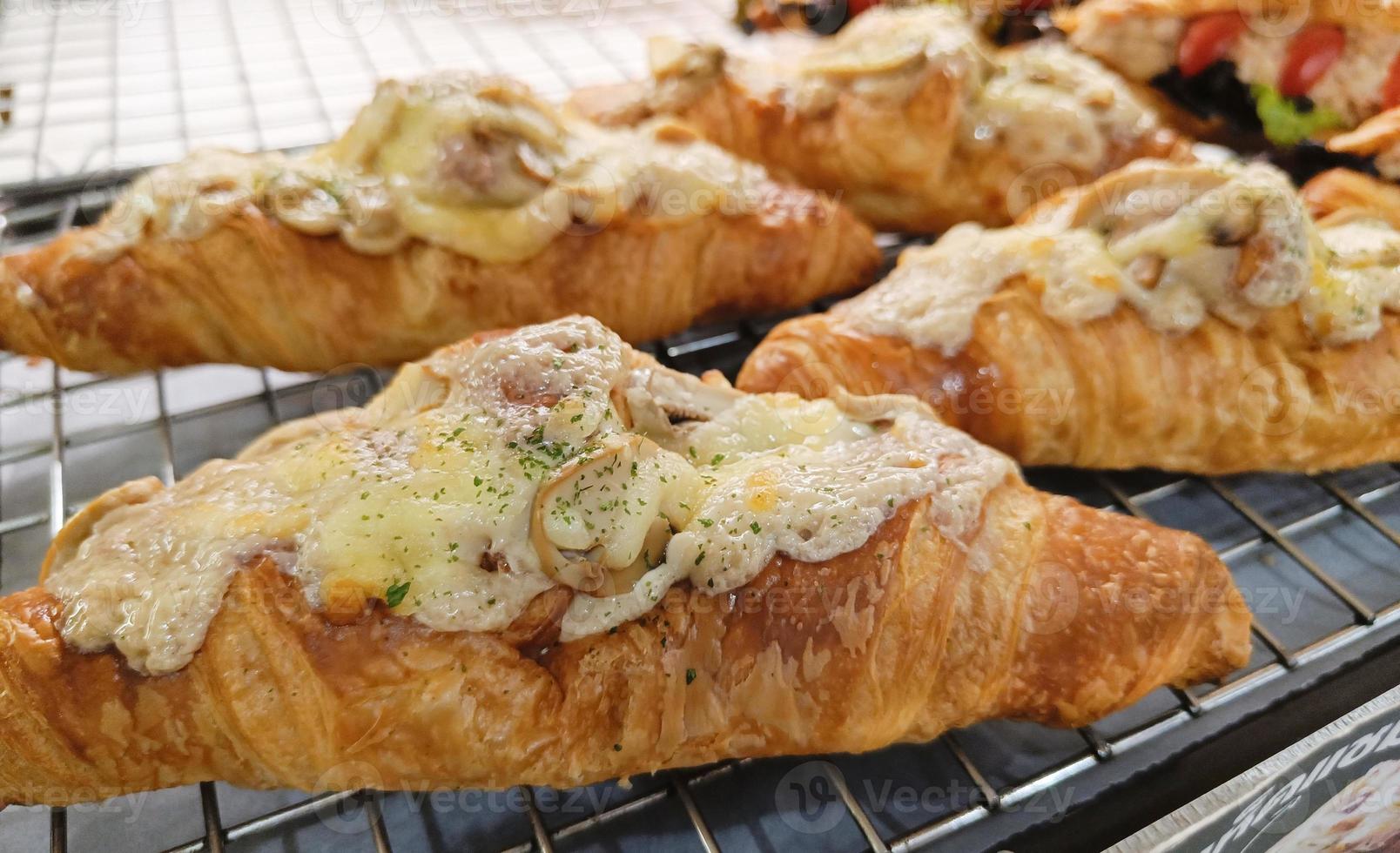 Closeup. Croissant with Mushrooms truffles on tray. photo