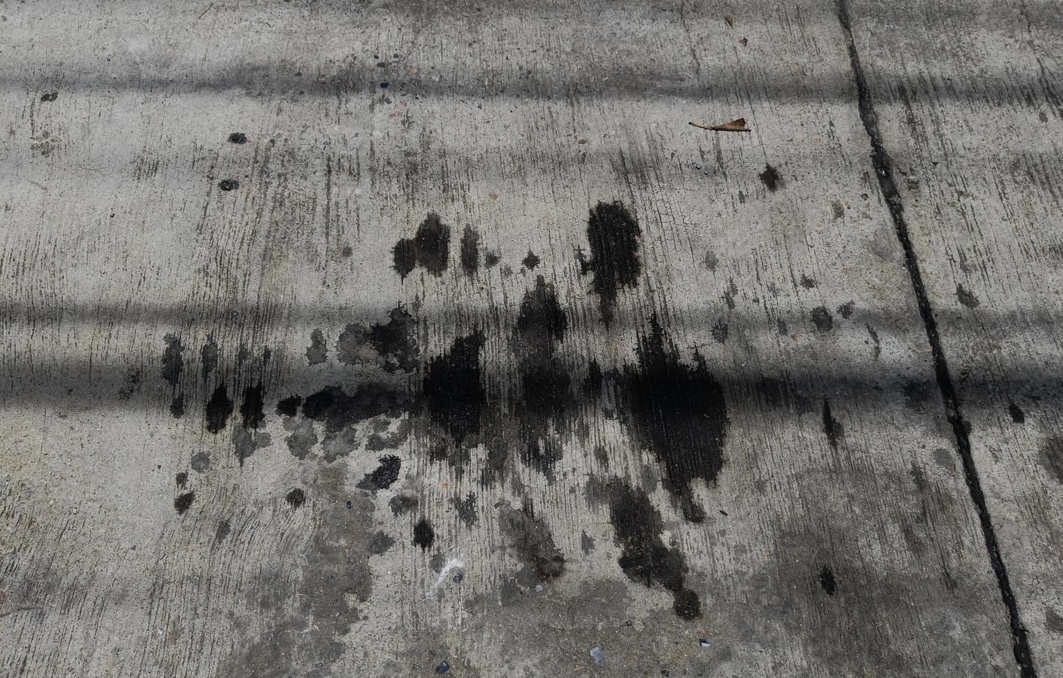 Stains of engine oil from cars that drip onto the cement floor photo