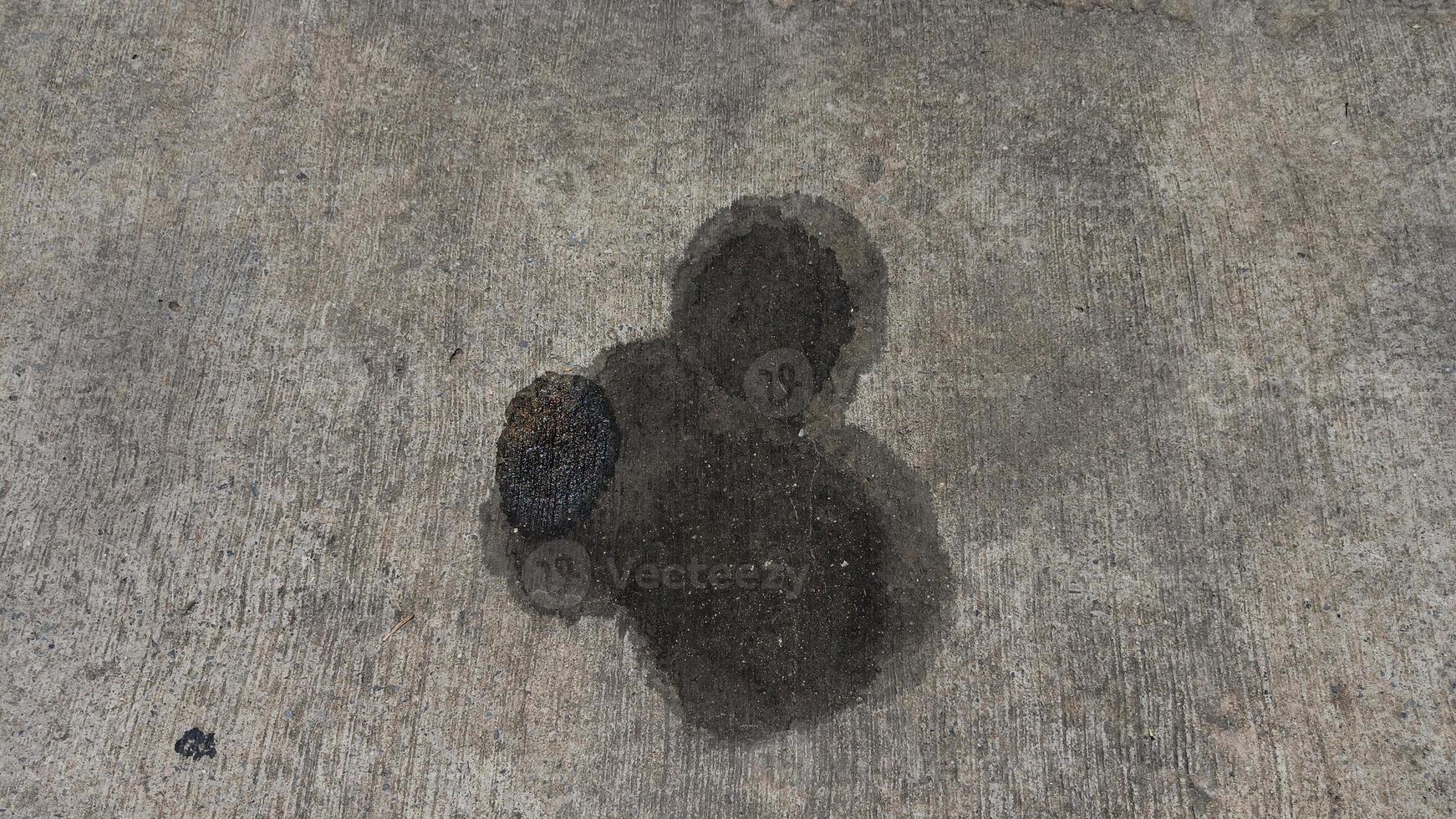 Stains of engine oil from cars that drip onto the floor in the parking lot or cement floor photo