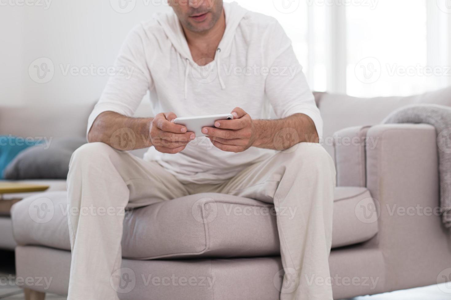 young man using a mobile phone  at home photo