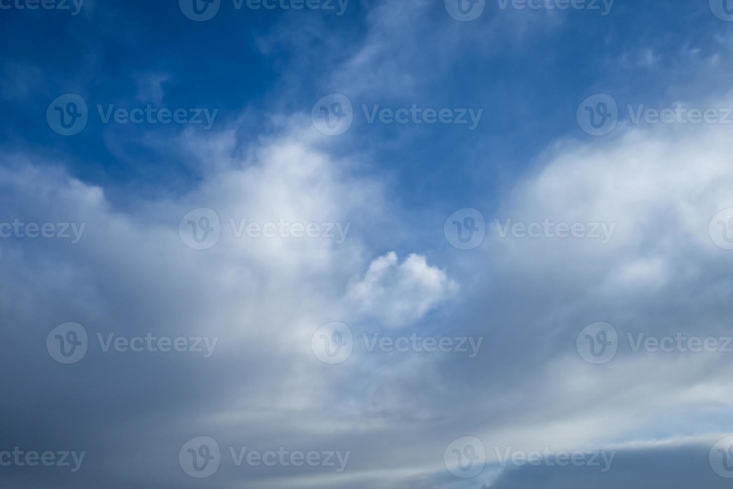 Blue sky background with tiny stratus cirrus striped clouds. Clearing day and Good windy weather photo
