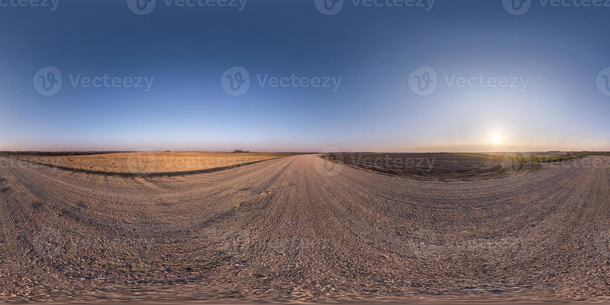 full seamless spherical hdr panorama 360 degrees angle view on no traffic gravel road among fields in spring evening with clear sky in equirectangular projection, for VR AR virtual reality content photo