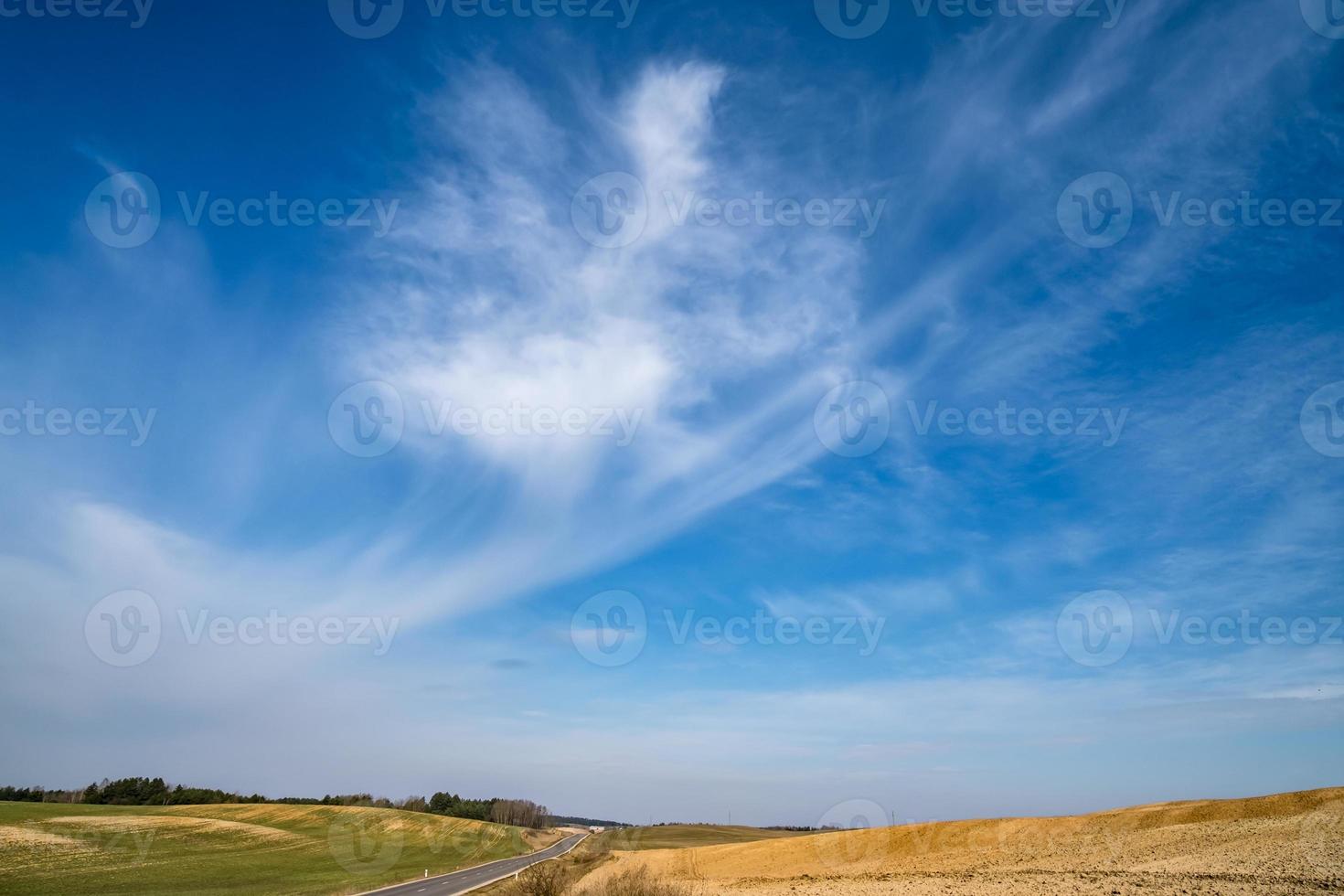 Blue sky background with tiny stratus cirrus striped clouds. Clearing day and Good windy weather photo