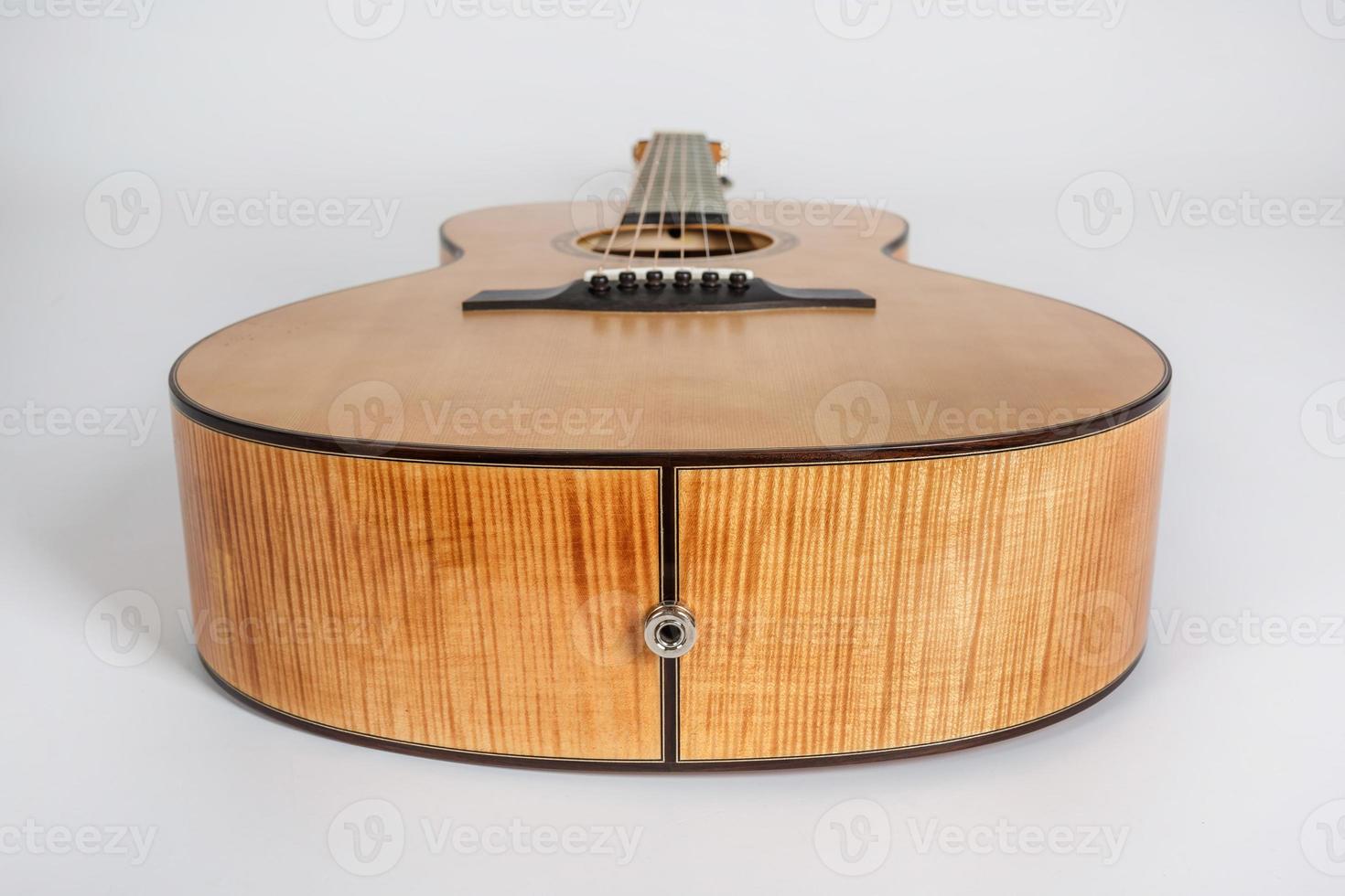 wood texture of lower deck of six strings acoustic guitar on white background. guitar shape photo