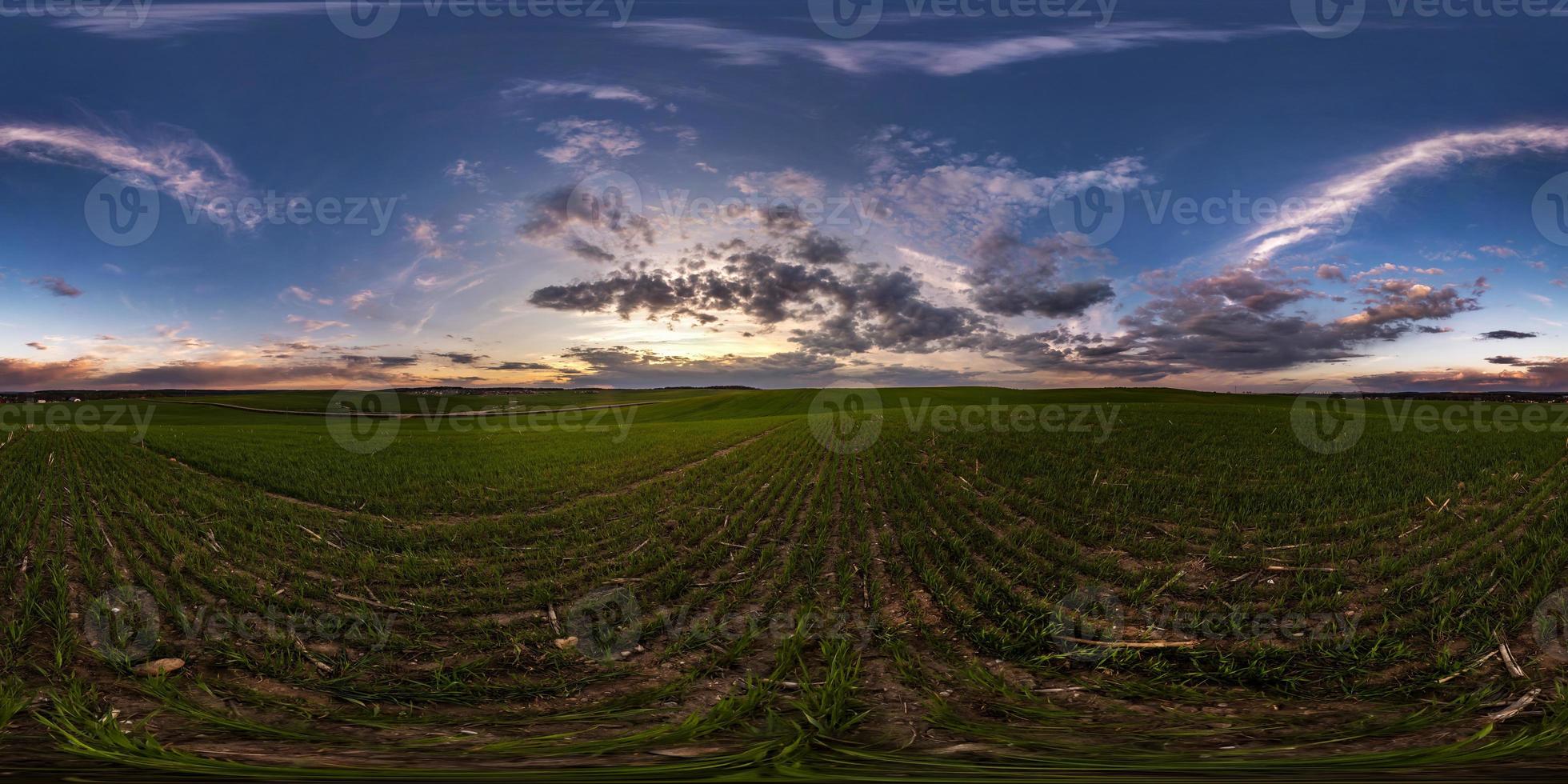 full seamless spherical hdri panorama 360 degrees angle view on among fields in spring evening before sunset with awesome clouds in equirectangular projection, ready for VR AR virtual reality content photo