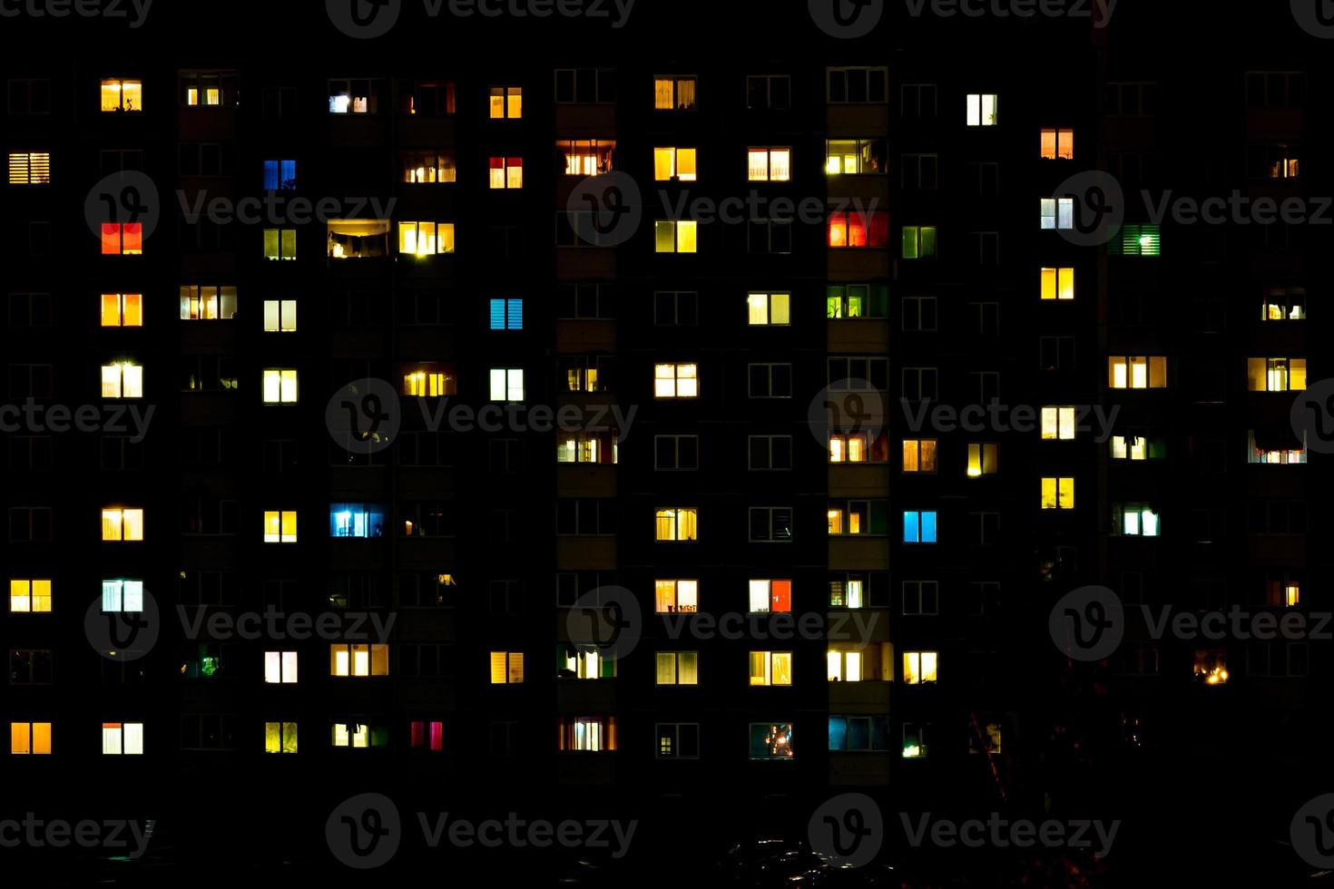 Flat night panorama of multicolor light in windows of multistory buildings. life in big city photo