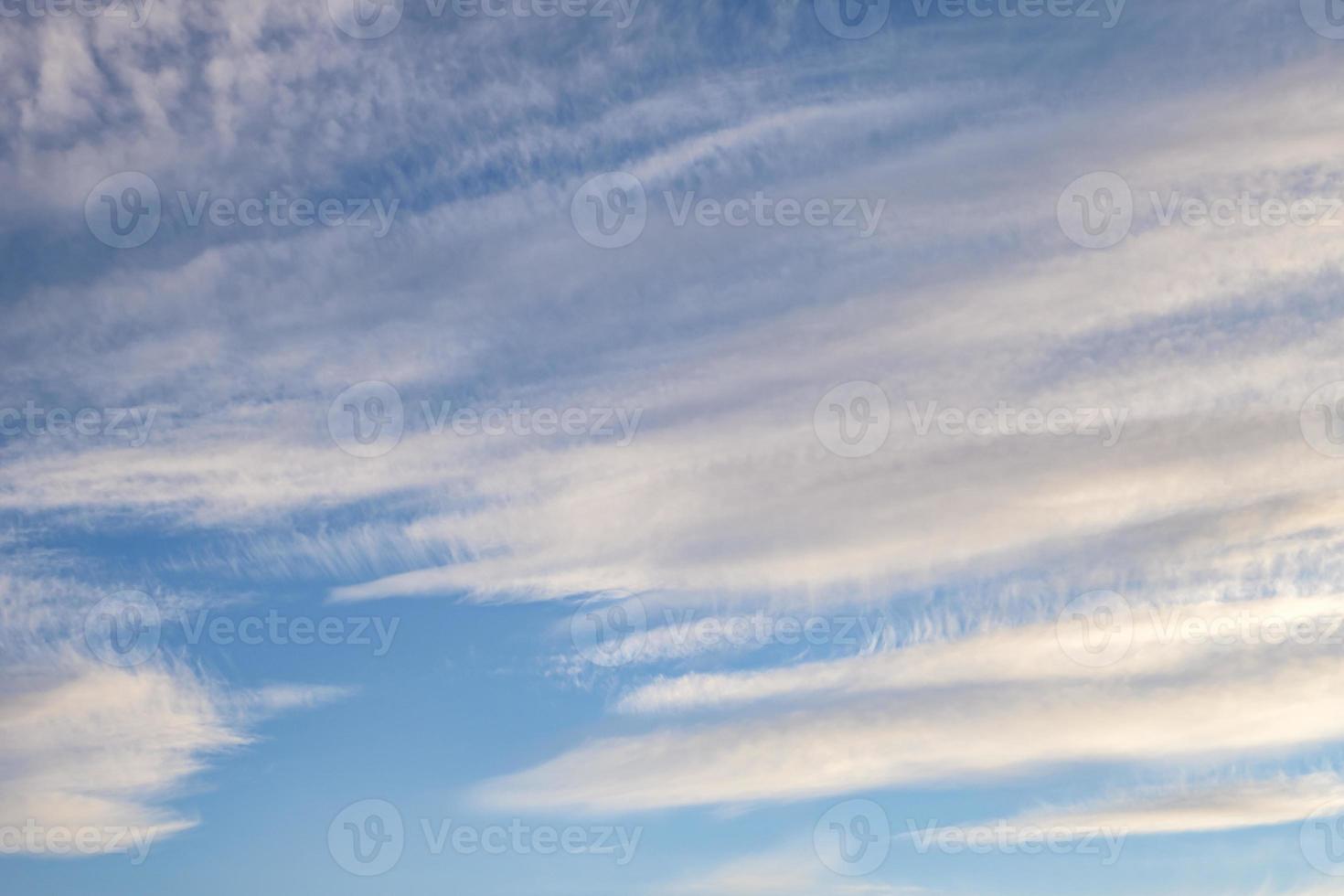 Blue sky background with tiny stratus cirrus striped clouds. Clearing day and Good windy weather photo
