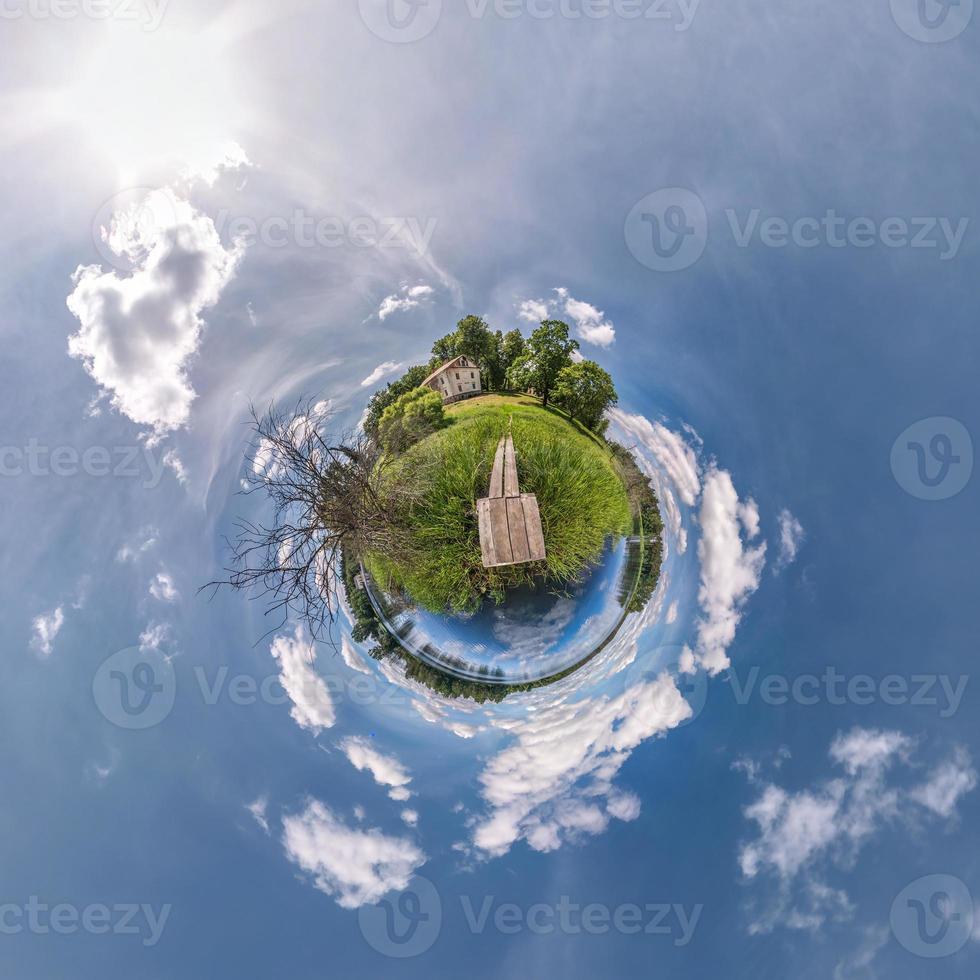 Little planet transformation of spherical panorama 360 degrees. Spherical abstract aerial view in field with awesome beautiful clouds. Curvature of space. photo