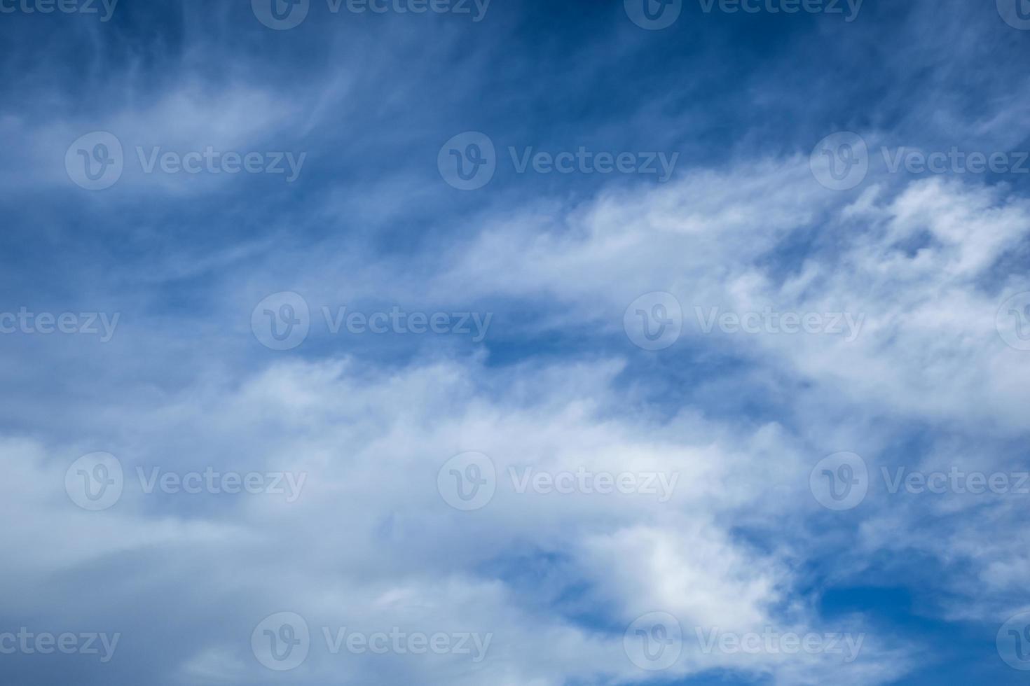 Blue sky background with tiny stratus cirrus striped clouds. Clearing day and Good windy weather photo