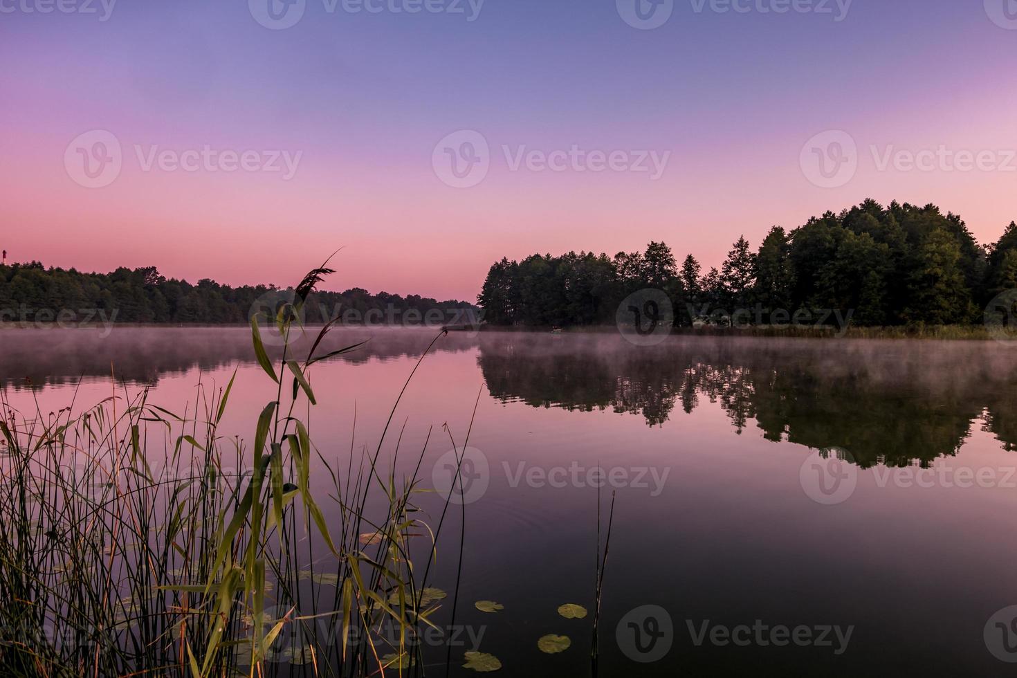 panorama on huge lake or river in morning with beautiful awesome pink sunrise photo