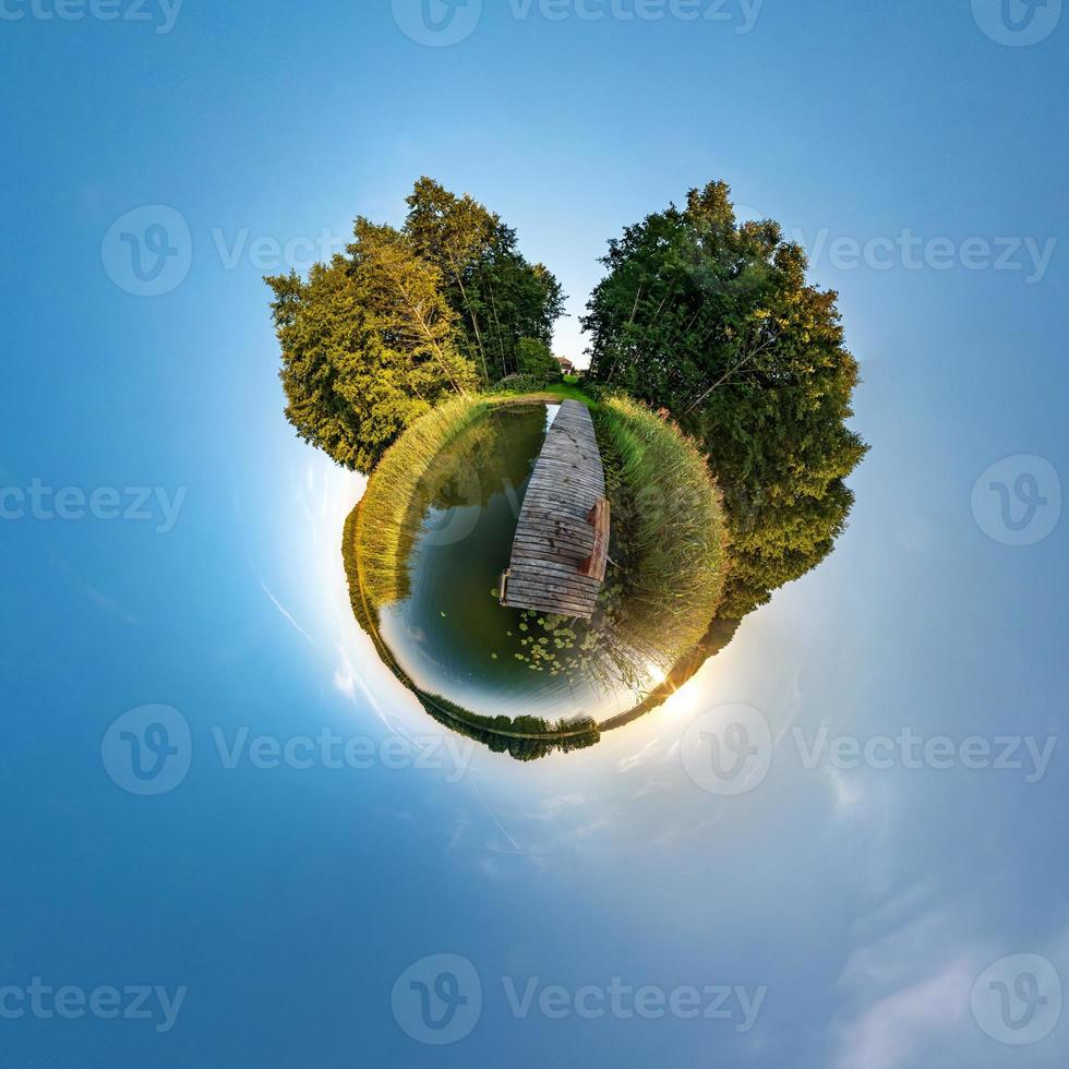 Little planet transformation of spherical panorama 360 degrees. Spherical abstract aerial view in field with awesome beautiful clouds. Curvature of space. photo