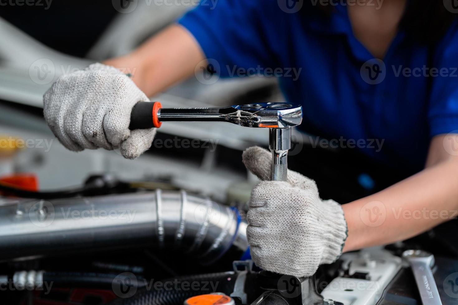 Close-up of an expert mechanic working on a vehicle in a car service. Engine. Motor repair. Auto mechanic. Auto mechanic. photo
