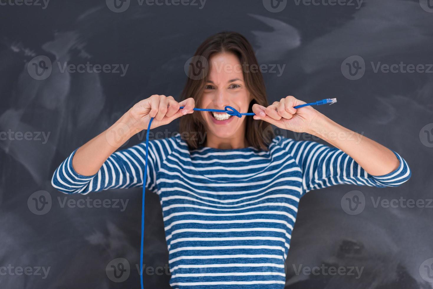 woman holding a internet cable in front of chalk drawing board photo