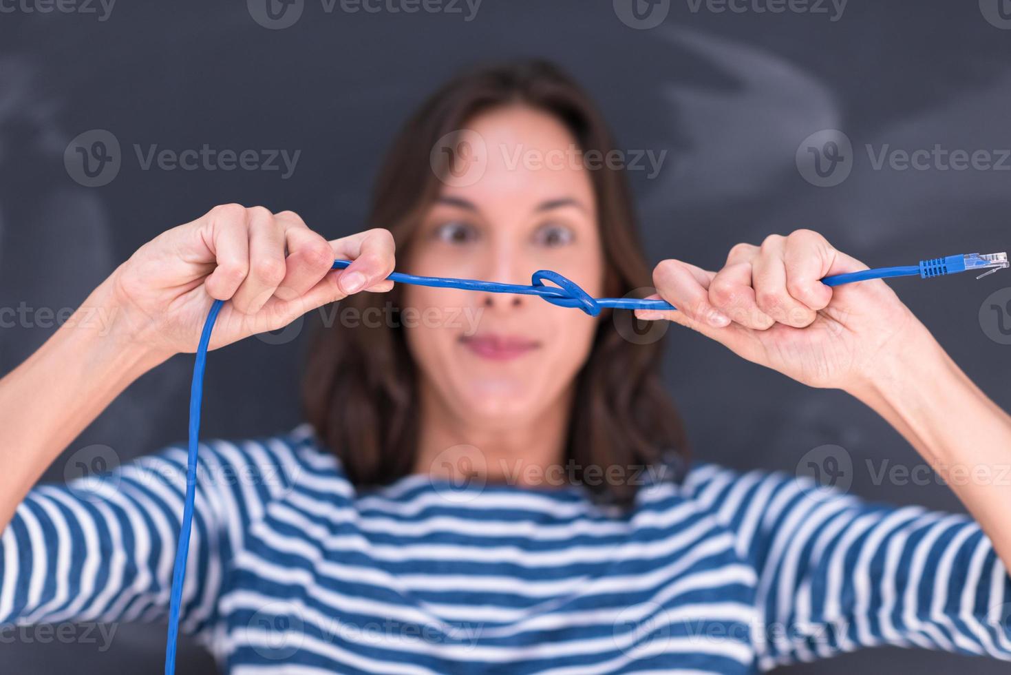 woman holding a internet cable in front of chalk drawing board photo