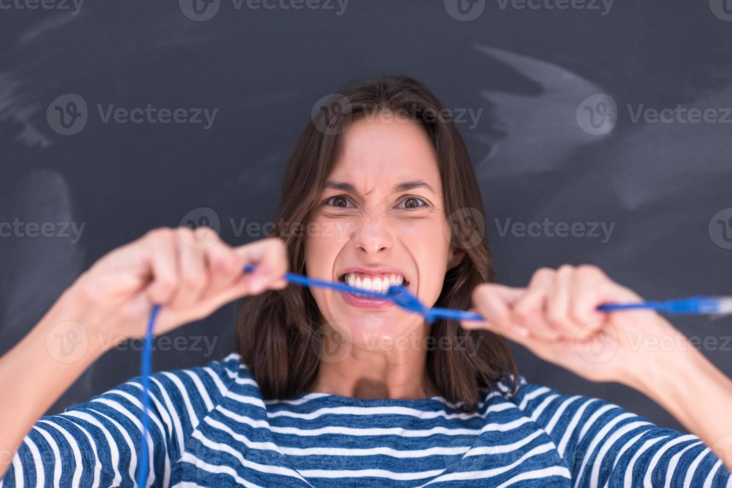 woman holding a internet cable in front of chalk drawing board photo