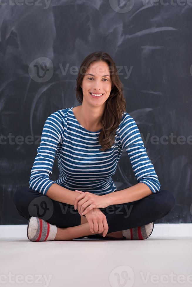 woman sitting in front of chalk drawing board photo