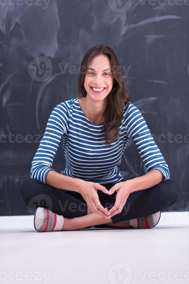 woman sitting in front of chalk drawing board photo