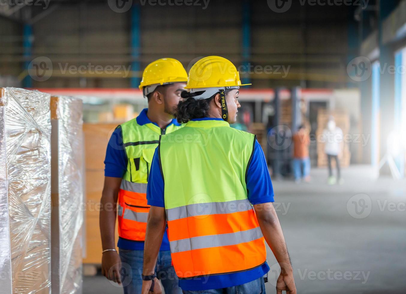 Warehouse workers working in logistics center, Workers team taking inventory in factory warehouse, Manual workers working in warehouse talking about job photo