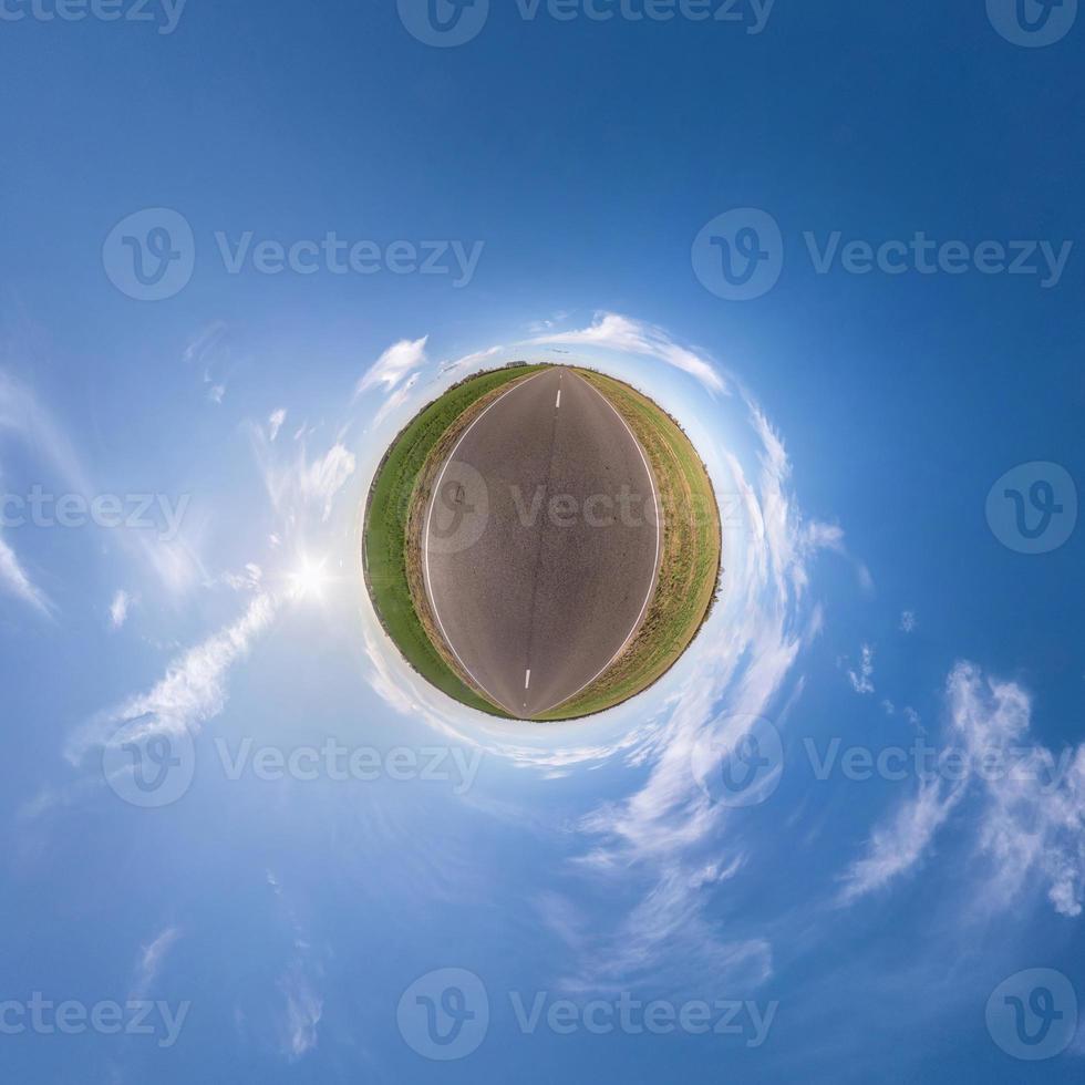 Little planet transformation of spherical panorama 360 degrees. Spherical abstract aerial view in field with awesome beautiful clouds. Curvature of space. photo