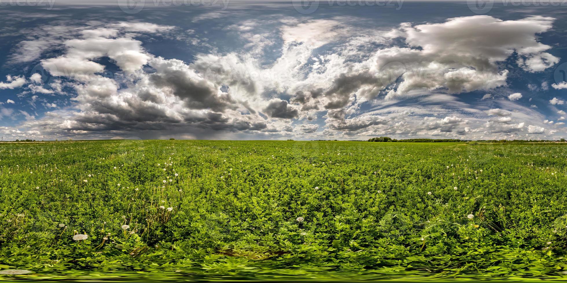 full seamless spherical hdri panorama 360 degrees angle view on among fields in spring day with awesome clouds before storm in equirectangular projection, ready for VR AR virtual reality content photo