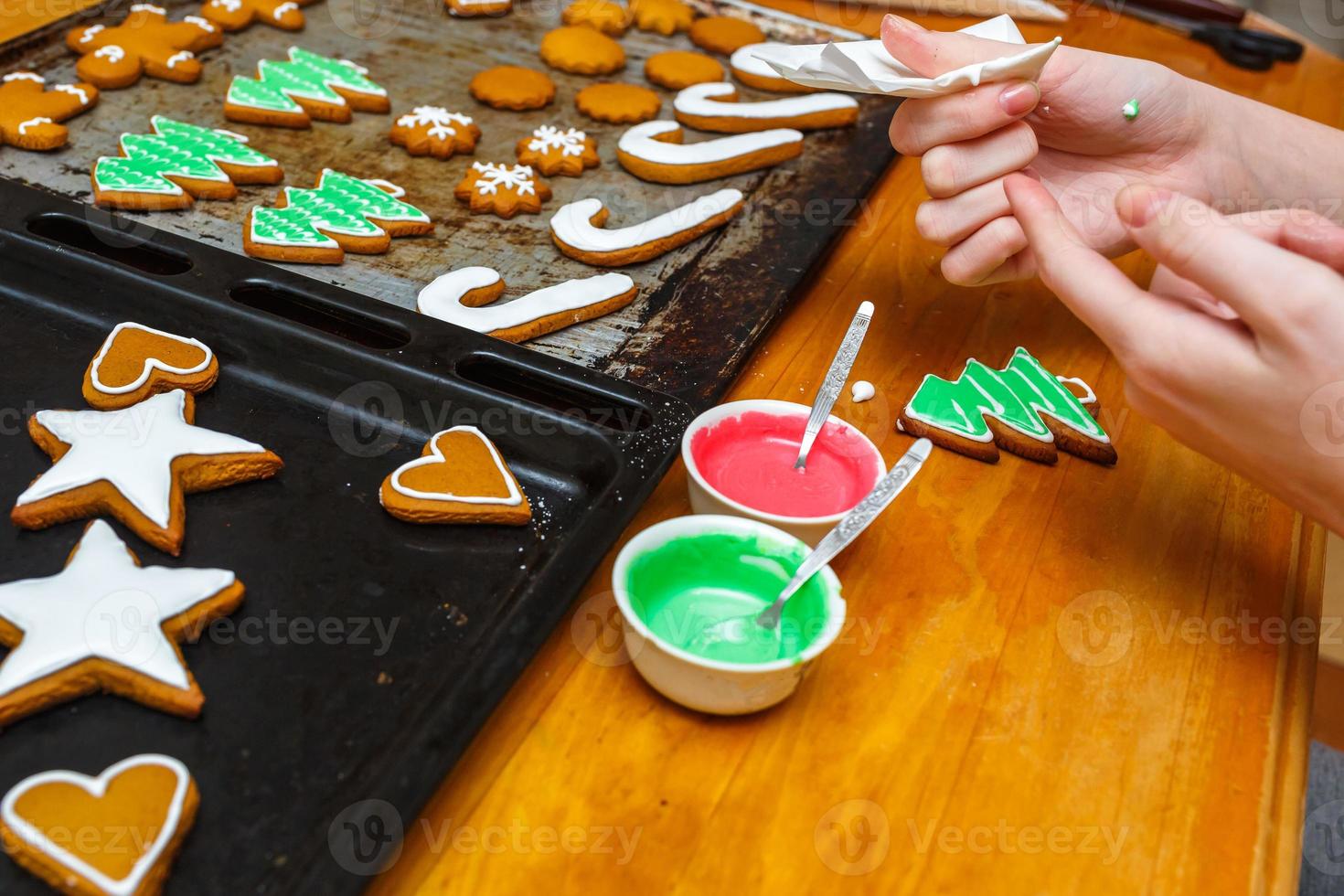 Handmade festive gingerbread cookies in the form of stars, snowflakes, people, socks, staff, mittens, Christmas trees, hearts for xmas and new year holiday. hand coloring cookies photo