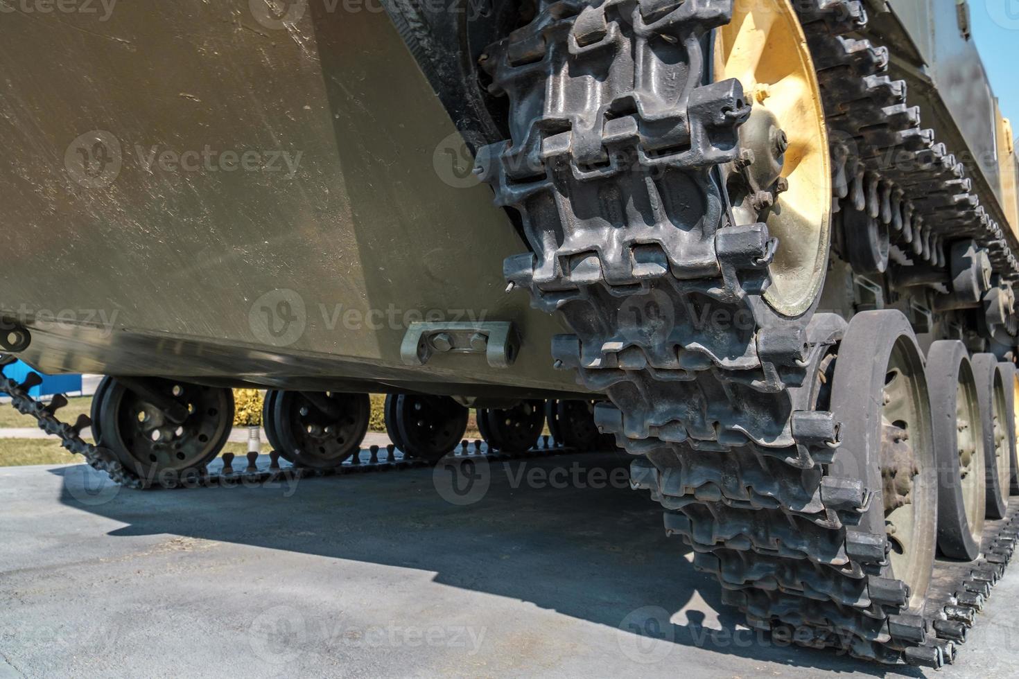 tracks and wheels of tank, armored vehicles on the street in green khaki color photo