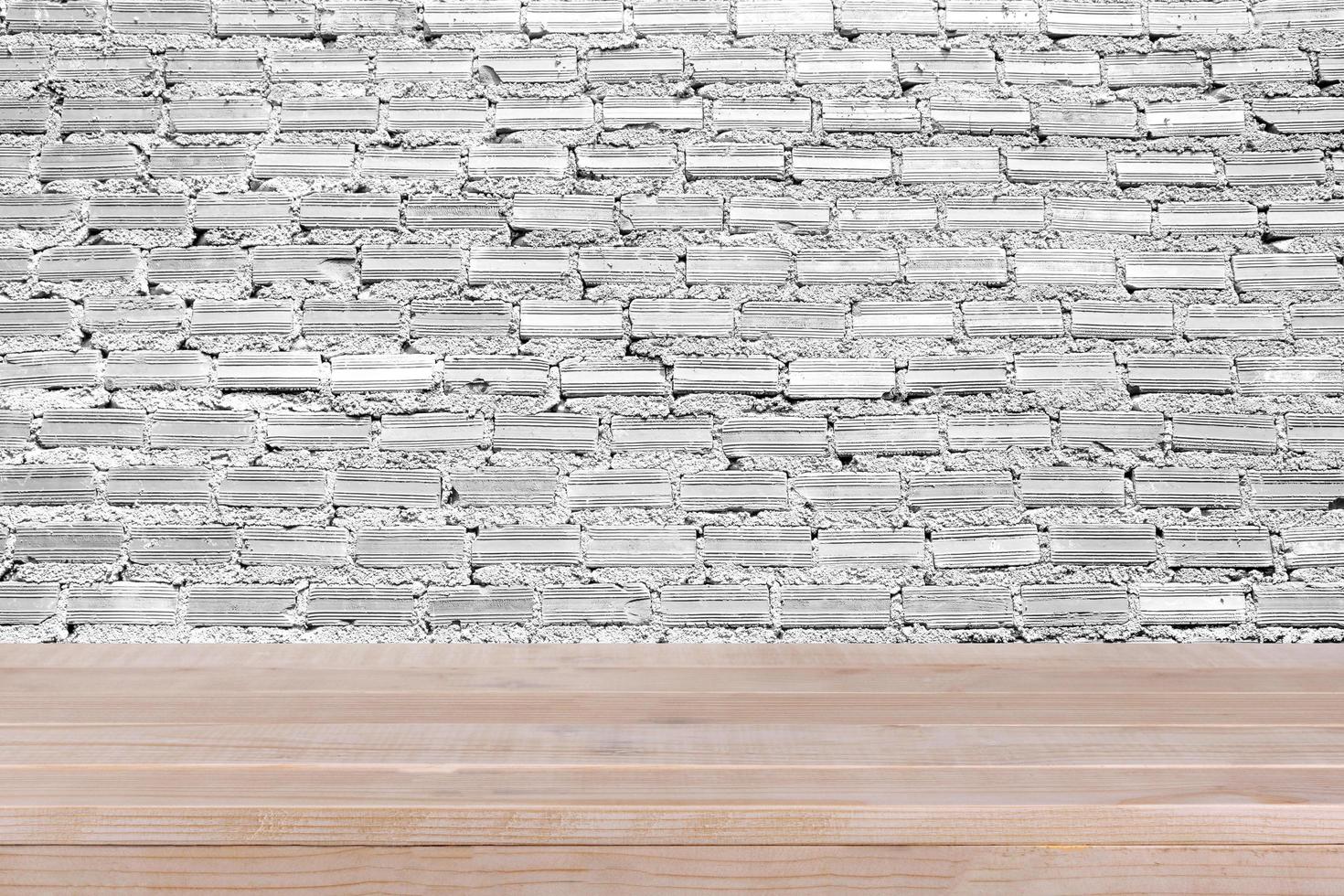 brown wood table top on white concrete wall background - can be used for montage or display your products photo