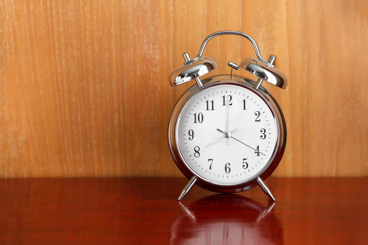 alarm table clock on wood table photo