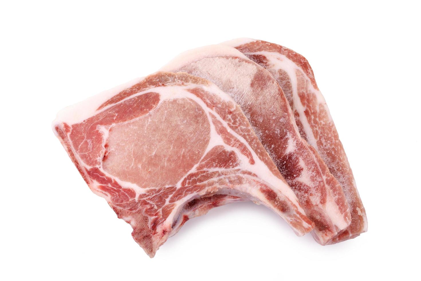 three slice uncooked pork chops ,frozen pork chops photo
