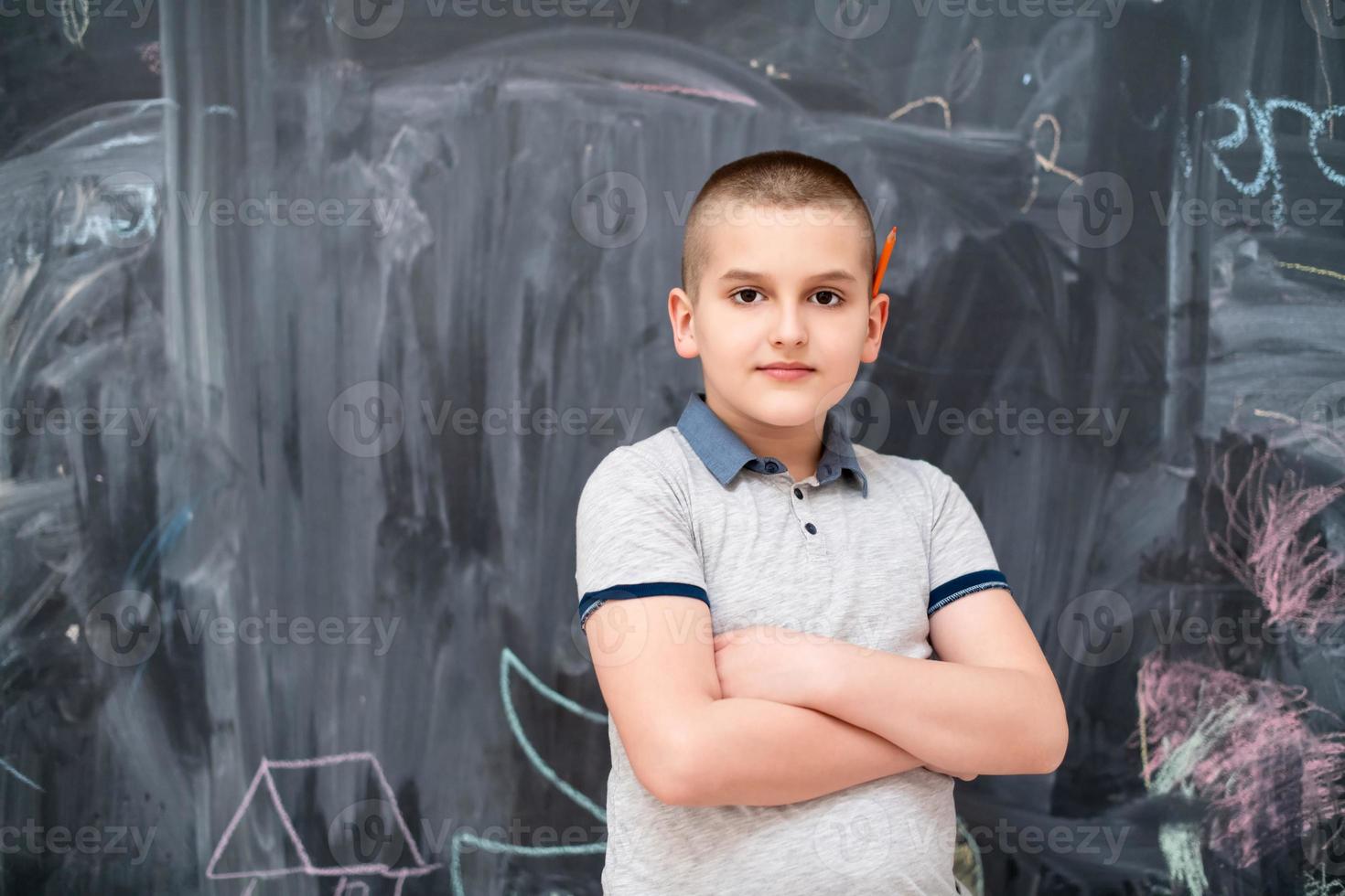 portrait of little boy in front of chalkboard photo