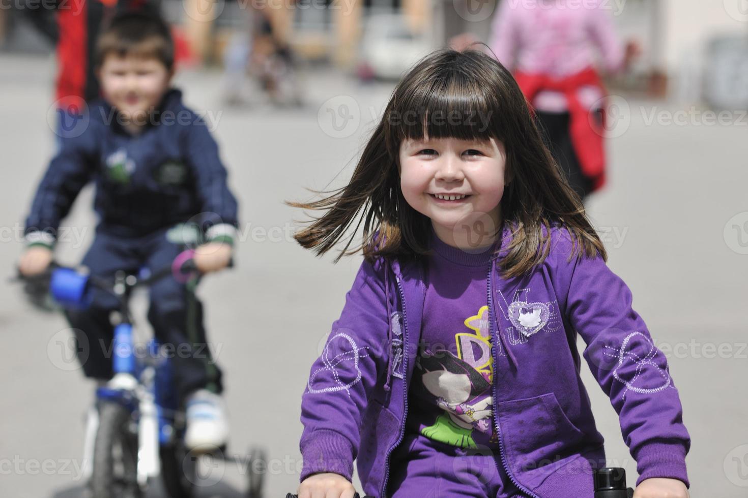 happy childrens group learning to drive bicycle photo