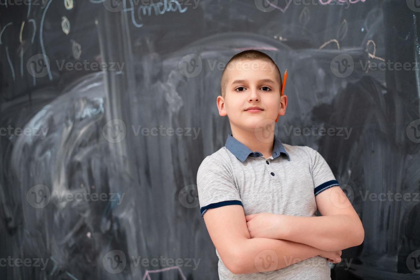 portrait of little boy in front of chalkboard photo