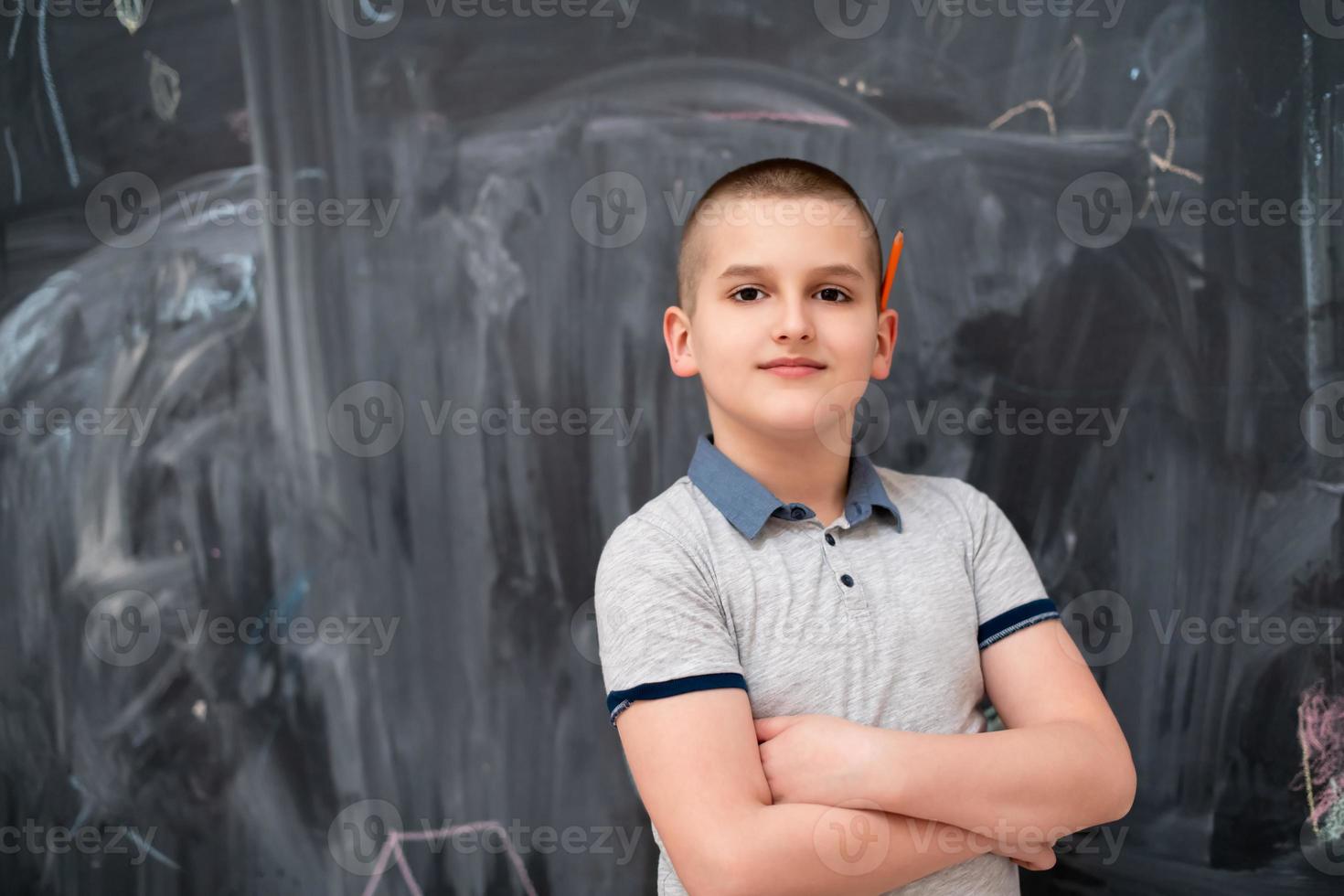 portrait of little boy in front of chalkboard photo