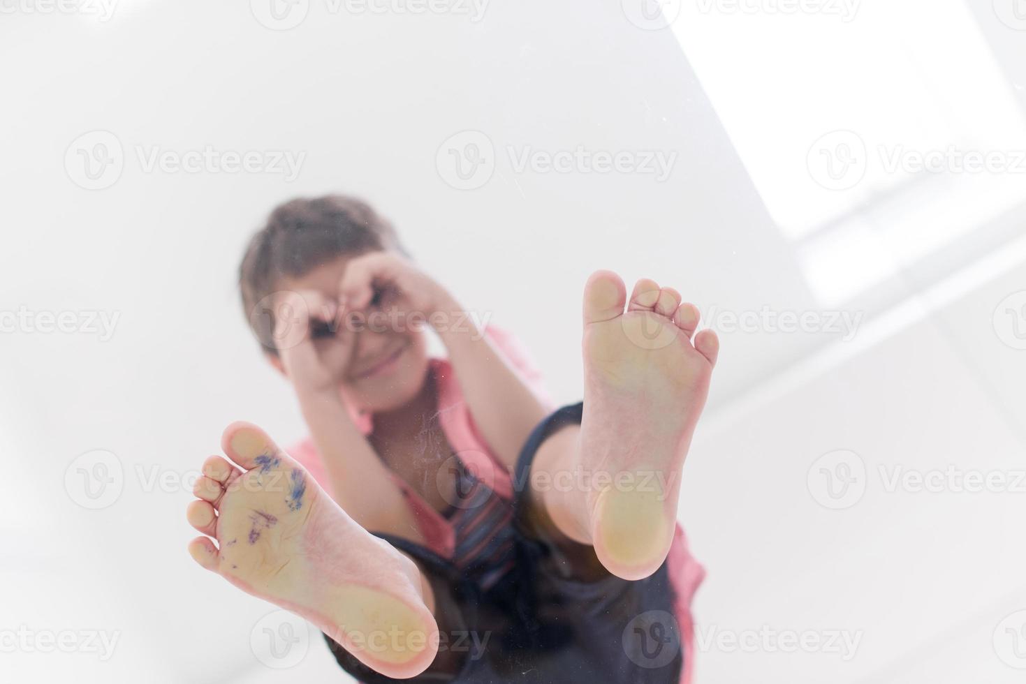 little boy standing on transparent glass floor photo