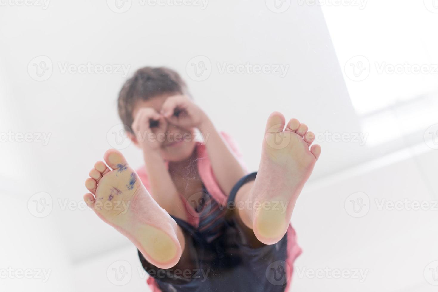 little boy standing on transparent glass floor photo