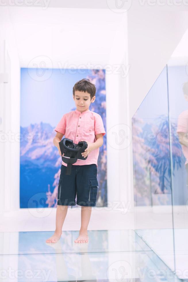 kid at home wearing vr glasses photo