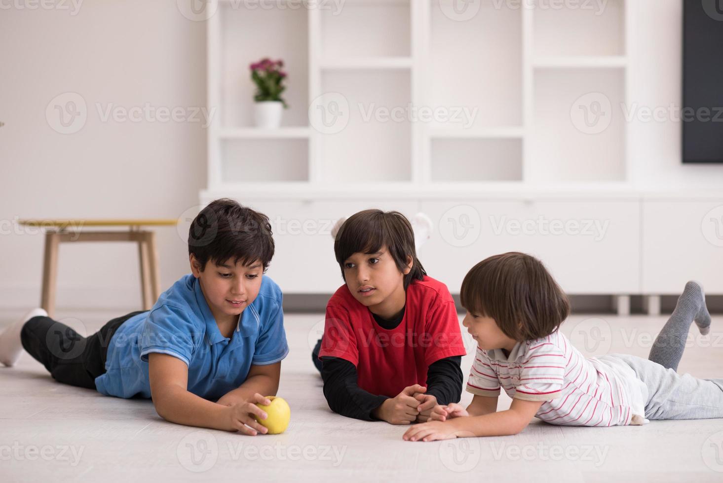 boys having fun with an apple on the floor photo