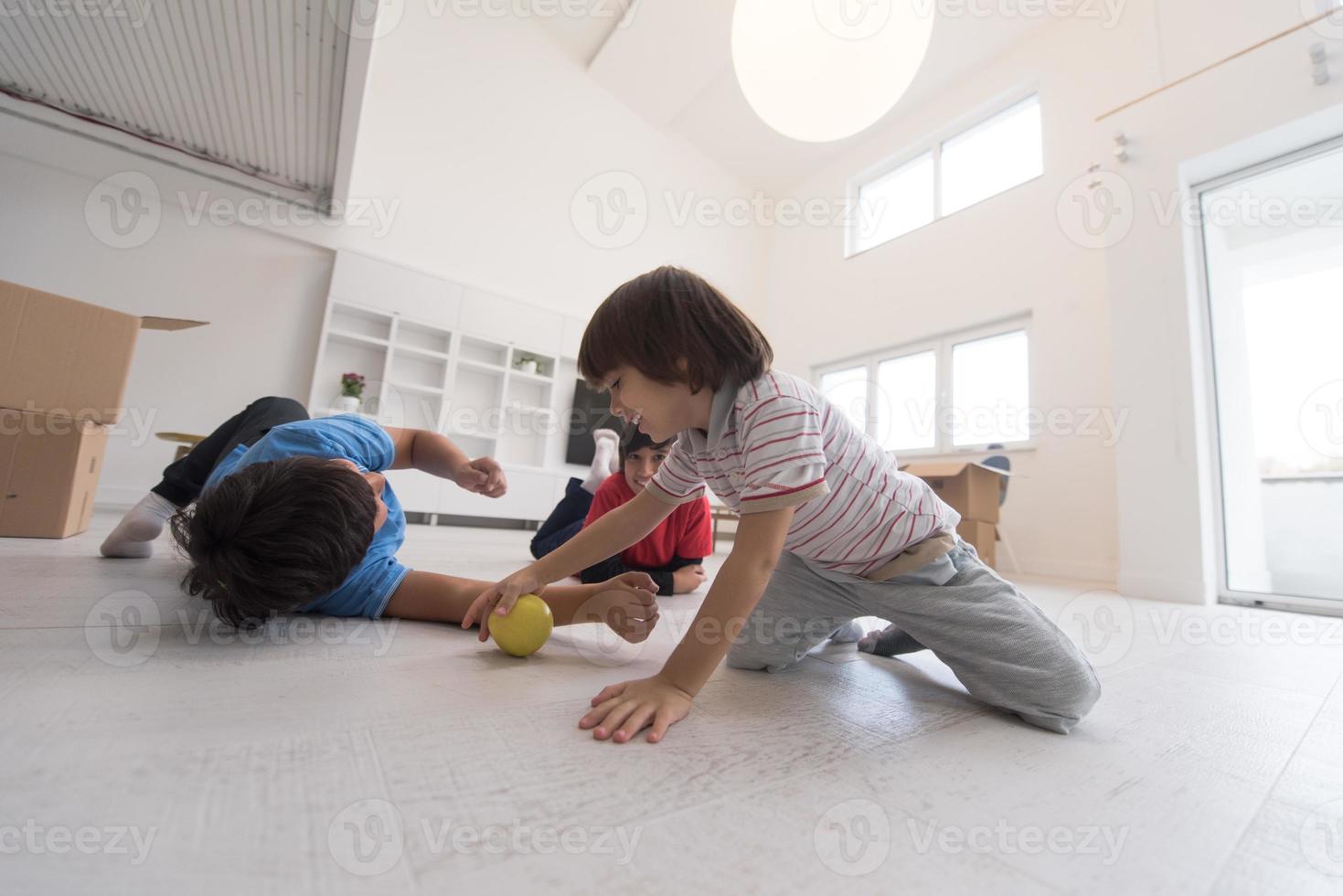 boys having fun with an apple on the floor photo